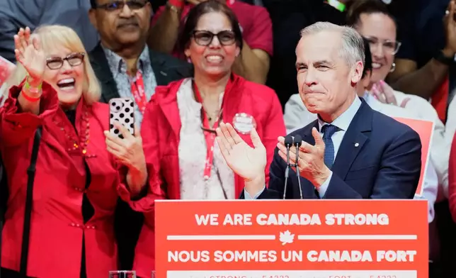 Canadian Prime Minister Mark Carney claps on stage at his campaign headquarters after the Liberal Party won the Canadian election in Ottawa, Ontario, Tuesday, April 29, 2025. (Frank Gunn/The Canadian Press via AP)
