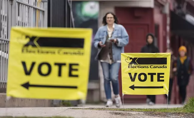 Elections Canada signage is seen as voters arrive at a polling station on Election Day in Halifax, Canada, Monday, April 28, 2025. (Darren Calabrese/The Canadian Press via AP)