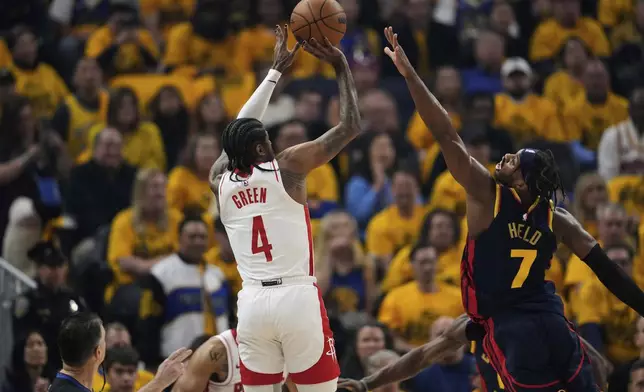 Houston Rockets guard Jalen Green (4) shoots a 3-point basket over Golden State Warriors guard Buddy Hield (7) during the first half of Game 4 of an NBA basketball first-round playoff series Monday, April 28, 2025, in San Francisco. (AP Photo/Godofredo A. Vásquez)