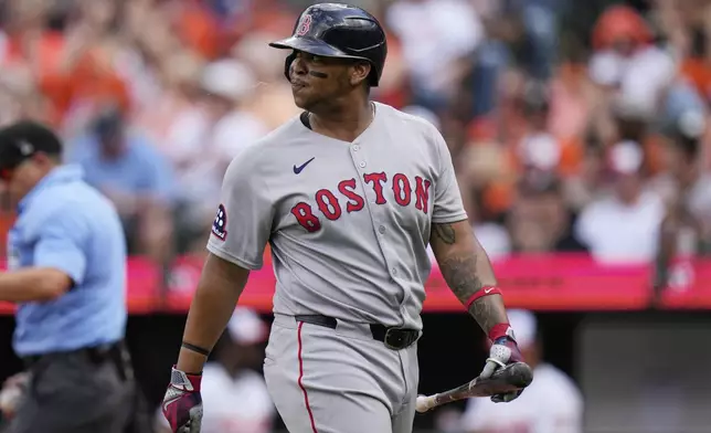 Boston Red Sox's Rafael Devers reacts after striking out during the second inning of an opening-day baseball game against the Baltimore Orioles, Monday, March 31, 2025, in Baltimore. (AP Photo/Stephanie Scarbrough)