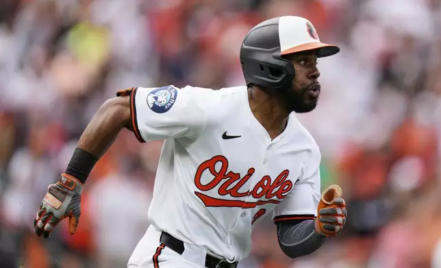 Baltimore Orioles' Cedric Mullins advances toward first base after hitting a two-run RBI double during the first inning of an opening-day baseball game against the Boston Red Sox, Monday, March 31, 2025, in Baltimore. (AP Photo/Stephanie Scarbrough)