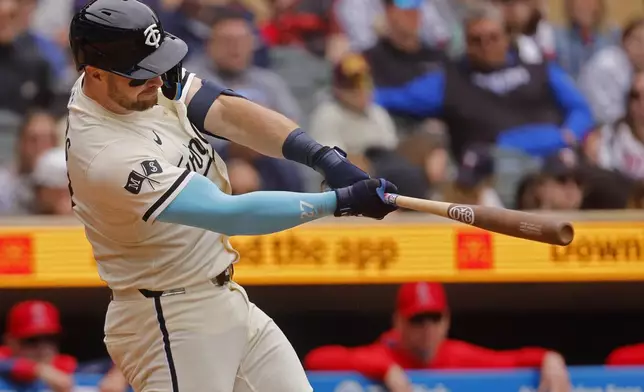 Minnesota Twins' Ryan Jeffers hits a two-RBI double against the Los Angeles Angels in the sixth inning of a baseball game Sunday, April 27, 2025, in Minneapolis. (AP Photo/Bruce Kluckhohn)