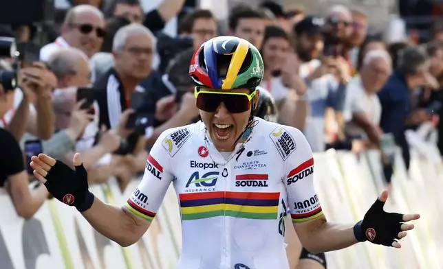 Mauritius' Kim Le Court de Billot of the AG Insurance Soudal team crosses the finish line to win the Belgian cycling classic and UCI World Tour race Liege Bastogne Liege, in Liege, Belgium, Sunday, April 27, 2025. (AP Photo/Geert Vanden Wijngaert)