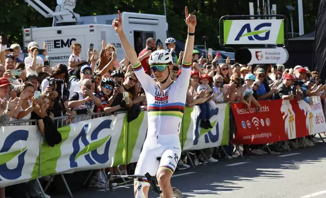 Slovenia's Tadej Pogacar of the UAE Team Emirates URG team crosses the finish line to win the Belgian cycling classic and UCI World Tour race Liege Bastogne Liege, in Liege, Belgium, Sunday, April 27, 2025. (AP Photo/Geert Vanden Wijngaert)