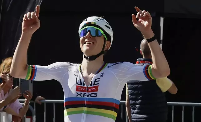 Slovenia's Tadej Pogacar of the UAE Team Emirates URG team crosses the finish line to win the Belgian cycling classic and UCI World Tour race Liege Bastogne Liege, in Liege, Belgium, Sunday, April 27, 2025. (AP Photo/Geert Vanden Wijngaert)
