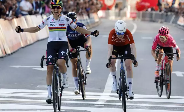 Mauritius' Kim Le Court de Billot of the AG Insurance Soudal team, left, crosses the finish line to win the Belgian cycling classic and UCI World Tour race Liege Bastogne Liege, in Liege, Belgium, Sunday, April 27, 2025. (AP Photo/Geert Vanden Wijngaert)