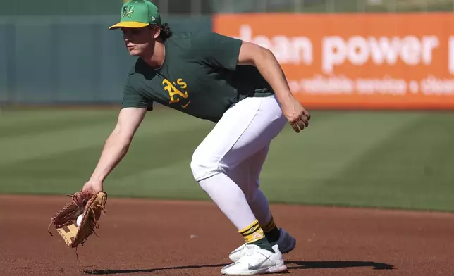 Athletics top prospect Nick Kurtz fields a ground ball during warmups of a baseball game against the Texas Rangers Tuesday, April 22, 2025, in West Sacramento, Calif. (AP Photo/Scott Marshall)