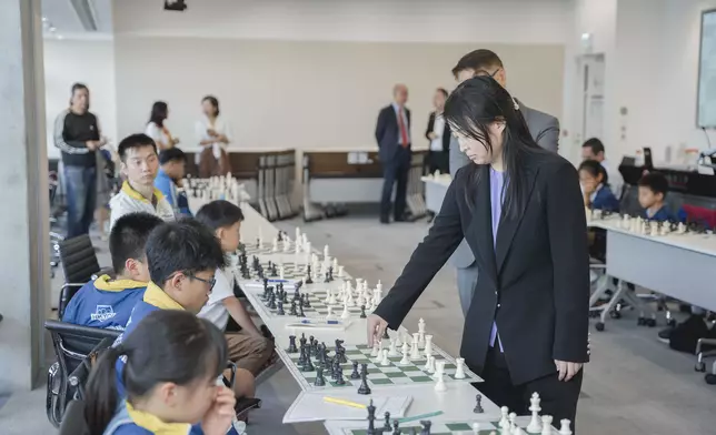 Five-Time World Champion, GM Ju Wenjun and Hong Kong Chess Players in Simultaneous Chess Exhibition .
