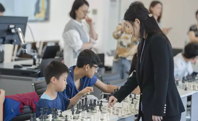 Five-Time World Champion, GM Ju Wenjun and Hong Kong Chess Players in Simultaneous Chess Exhibition .