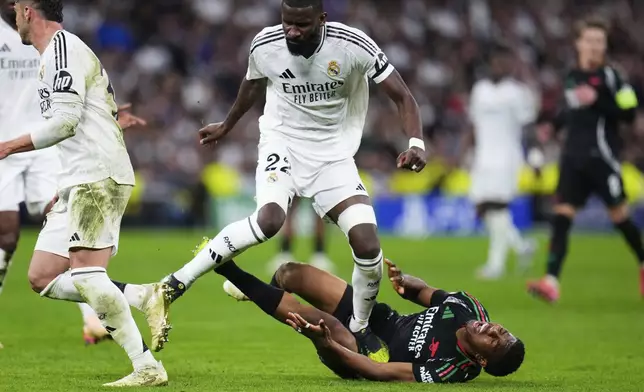 Real Madrid's Antonio Ruediger steps on Arsenal's Myles Lewis-Skelly, on the ground, during the Champions League quarterfinals second leg soccer match between Real Madrid and Arsenal at the Santiago Bernabeu stadium in Madrid, Wednesday, April 16, 2025. (AP Photo/Manu Fernandez)