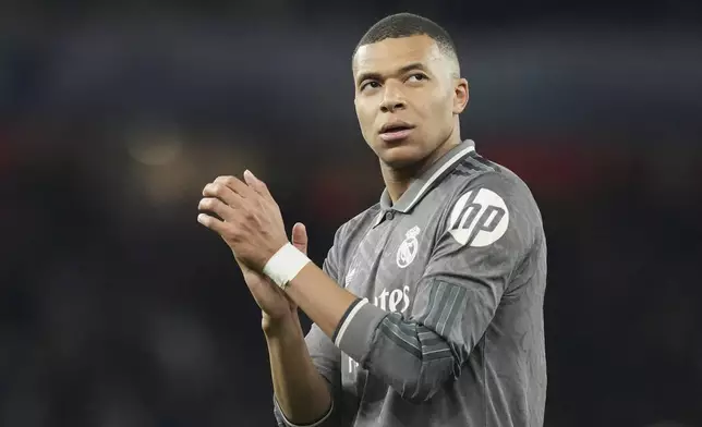 Real Madrid's Kylian Mbappe applauds fans at the end of the Champions League quarterfinal first leg soccer match between Arsenal and Real Madrid at the Emirates Stadium in London, Tuesday, April 8, 2025. (AP Photo/Frank Augstein)