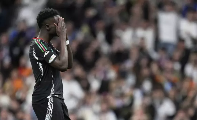Arsenal's Bukayo Saka reacts after missing a chance to score during the Champions League quarterfinals second leg soccer match between Real Madrid and Arsenal at the Santiago Bernabeu stadium in Madrid, Wednesday, April 16, 2025. (AP Photo/Bernat Armangue)