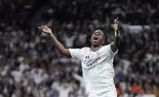 Real Madrid's Vinicius Junior reacts during the Champions League quarterfinals second leg soccer match between Real Madrid and Arsenal at the Santiago Bernabeu stadium in Madrid, Wednesday, April 16, 2025. (AP Photo/Bernat Armangue)