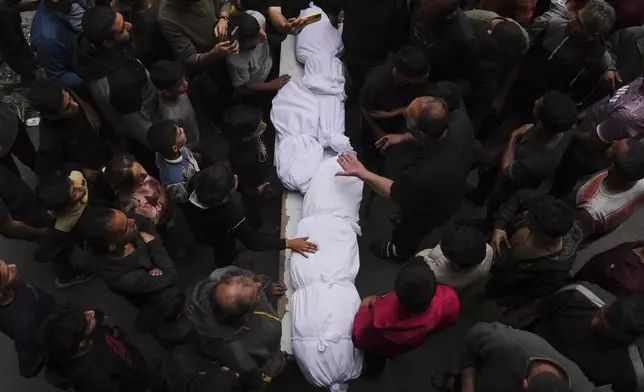 Relatives grieve over the bodies of members of the Jalis and Al-Sharbasi families, killed in an Israeli army airstrike on Yaffa School in Gaza City, Wednesday, April 23, 2025. (AP Photo/Jehad Alshrafi)