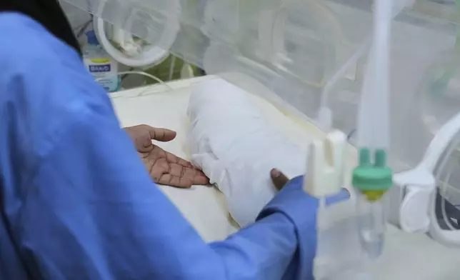 A nurse carries the body of a 15-days-old premature infant Sila Zidane after she died at Nasser Hospital in Khan Younis, Gaza, on Wednesday, April 23, 2025. (AP Photo/Abdel Kareem Hana)