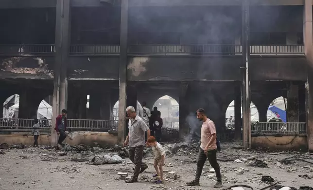 Palestinians inspect the damage after an Israeli army airstrike on Yaffa School, in Gaza City, Wednesday, April 23, 2025. (AP Photo/Jehad Alshrafi)