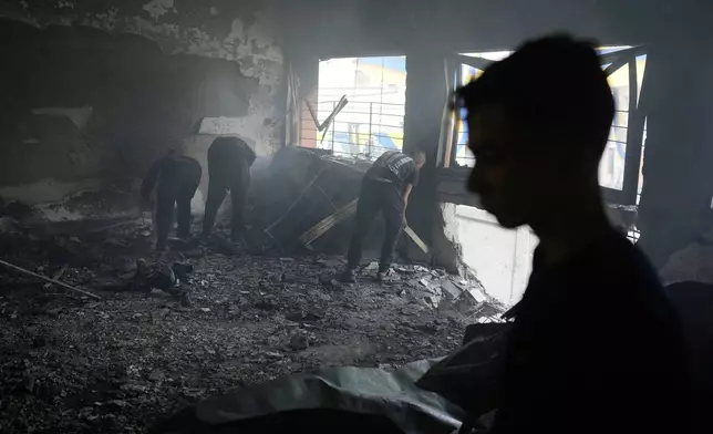 Palestinians inspect the damage after an Israeli airstrike early this morning on Yaffa School, in Gaza City, Wednesday, April 23, 2025. (AP Photo/Jehad Alshrafi)