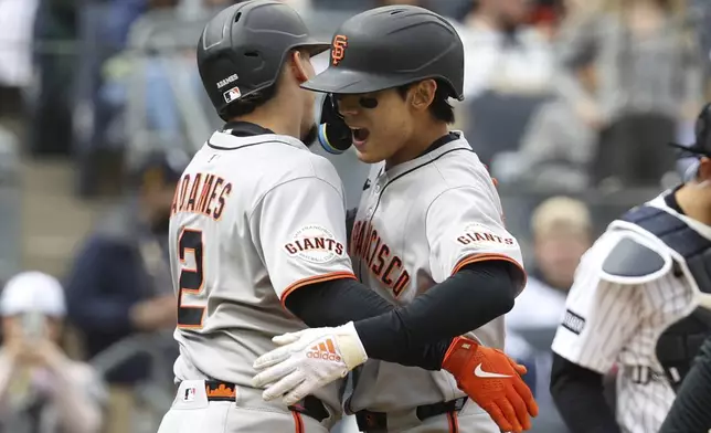 San Francisco Giants' Willy Adames, left, and Jung Hoo Lee, right, react after Lee hit a three run home run during the sixth inning of a baseball game against the New York Yankees Sunday, April 13, 2025, in New York. (AP Photo/Pamela Smith)