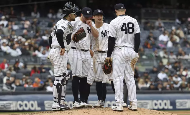 New York Yankees players talk on the pitcher's mound during the sixth inning of a baseball game against the San Francisco Giants Sunday, April 13, 2025, in New York. (AP Photo/Pamela Smith)