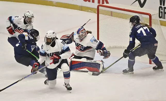 From left, Megan Keller of the U.S, Julia Schalin of Finland, Laila Edwards of the U.S., goalkeeper Aerin Frankel of the U.S. and Sanni Rantal of Finland in action during the ice hockey IIHF Women's World Championship Group A match between Finland and U.S., in Ceske Budejovice, Czech Republic, Wednesday, April 9, 2025. (Lubos Pavlicek/CTK via AP)
