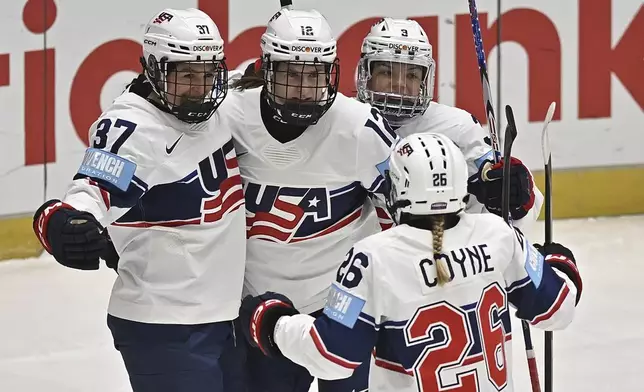 US players celebrate a goal during the ice hockey IIHF Women's World Championship Group A match between Finland and US, in Ceske Budejovice, Czech Republic, Wednesday, April 9, 2025. (Lubos Pavlicek/CTK via AP)