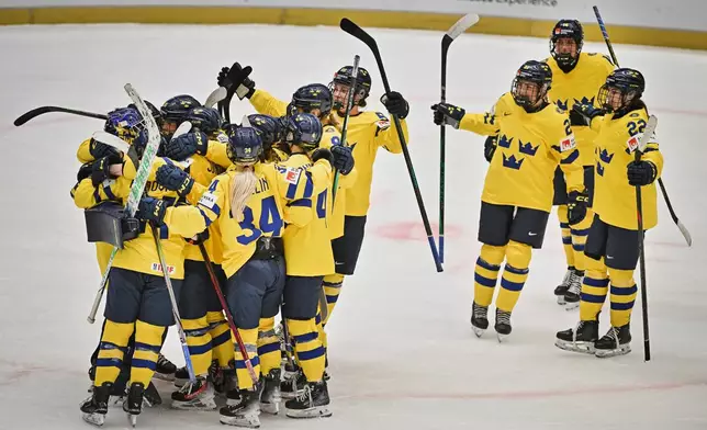 Swedish players celebrate victory after the IIHF Women's World Championship, Group B, match between Sweden and Germany, in Ceske Budejovice, Czech Republic, Wednesday, April 9, 2025. (Pavlicek Lubos/CTK via AP)