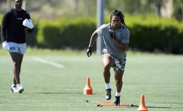 Wide receivers Kyle Williams, right, and Tory Horton train for the NFL football draft at Lake Forest Sports Park in Lake Forest, Calif., on Friday, March 21, 2025. (AP Photo/Damian Dovarganes)