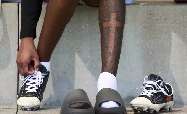 Wide receiver Tory Horton puts on his cleats as he prepares for the NFL football draft in Lake Forest, Calif., on Friday, March 21, 2025. (AP Photo/Damian Dovarganes)