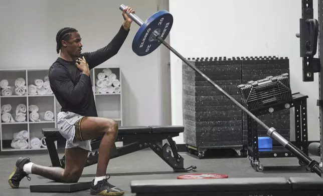 Wide receiver Tory Horton lifts weights as he prepares for the NFL football draft at a gym in Irvine, Calif., on Friday, March 21, 2025. (AP Photo/Damian Dovarganes)