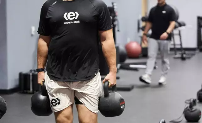 Offensive lineman Jonah Monheim lifts weights to prepare for the NFL Football draft in Irvine, Calif., on Friday, March 21, 2025. (AP Photo/Damian Dovarganes)