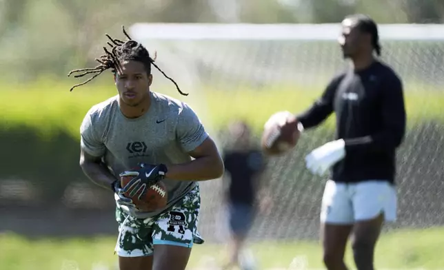 Wide receivers Kyle Williams, left, and Tory Horton train for the NFL football draft at Lake Forest Sports Park in Lake Forest, Calif., on Friday, March 21, 2025. (AP Photo/Damian Dovarganes)