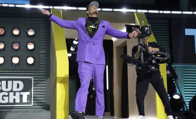 Arizona wide receiver Tetairoa McMillan celebrates after being chosen by the Carolina Panthers with the eighth overall pick during the first round of the NFL football draft, Thursday, April 24, 2025, in Green Bay, Wis. (AP Photo/Matt Ludtke)