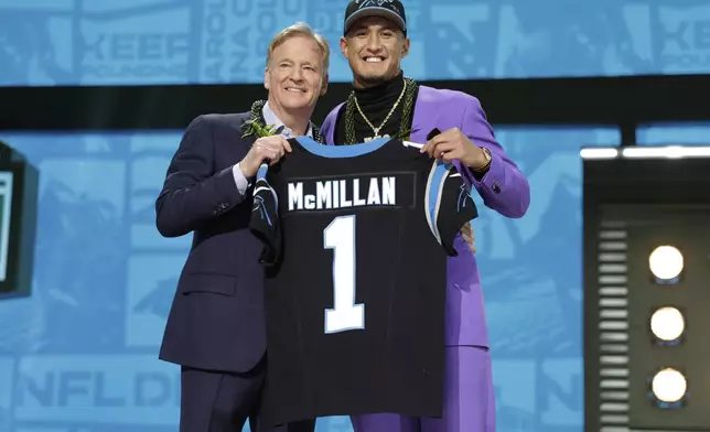 Arizona wide receiver Tetairoa McMillan, right, poses with NFL Commissioner Roger Goodell after being chosen by the Carolina Panthers with the eighth overall pick during the first round of the NFL football draft, Thursday, April 24, 2025, in Green Bay, Wis. (AP Photo/Matt Ludtke)