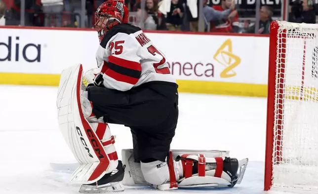 New Jersey Devils goaltender Jacob Markstrom (25) watches a replay of a goal by the Carolina Hurricanes during the second period of Game 5 of an NHL hockey Stanley Cup first-round playoff series in Raleigh, N.C., Tuesday, April 29, 2025. (AP Photo/Karl DeBlaker)