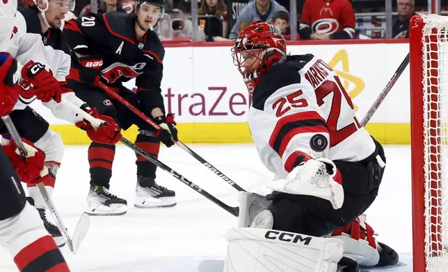 New Jersey Devils goaltender Jacob Markstrom (25) has a shot by Carolina Hurricanes' Sebastian Aho (20) go wide of the net during the second period of Game 5 of an NHL hockey Stanley Cup first-round playoff series in Raleigh, N.C., Tuesday, April 29, 2025. (AP Photo/Karl DeBlaker)