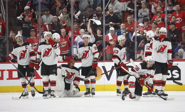 New Jersey Devils react following their overtime loss to the Carolina Hurricanes during the second overtime period of Game 5 of an NHL hockey Stanley Cup first-round playoff series in Raleigh, N.C., Tuesday, April 29, 2025. (AP Photo/Karl DeBlaker)