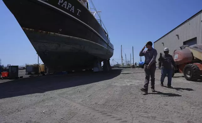 Manager Ken Garcia, left, visits a shrimp boat being refurbished for their Quality Seafood fleet, Wednesday, April 9, 2025, in Palacios, Texas. (AP Photo/Eric Gay)