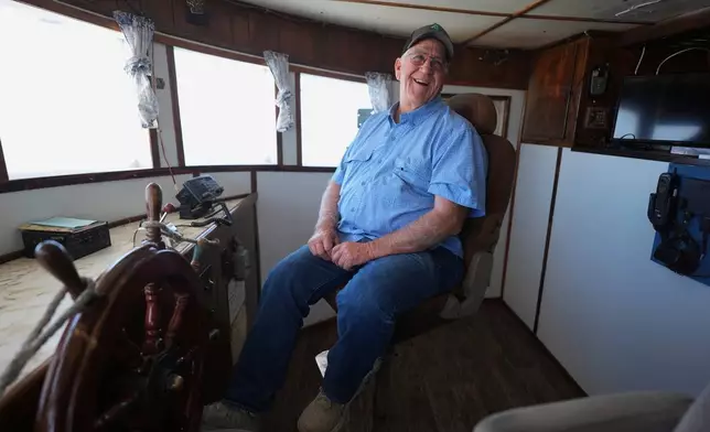 Craig Wallis, owner of W&amp;W Dock and Ice sits in the captain's seat of one of his docked shrimp boats, Wednesday, April 9, 2025, in Palacios, Texas. (AP Photo/Eric Gay)