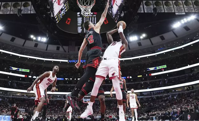 Miami Heat center Bam Adebayo, right, shoots against Chicago Bulls forward Zach Collins during the first half of an NBA play-in tournament basketball game in Chicago, Wednesday, April 16, 2025. (AP Photo/Nam Y. Huh)