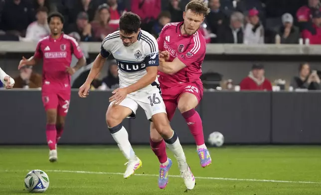 Vancouver Whitecaps' Sebastian Berhalter (16) and St. Louis City's Cedric Teuchert collide while battling for the ball during the second half of an MLS soccer match Saturday, April 19, 2025, in St. Louis. (AP Photo/Jeff Roberson)