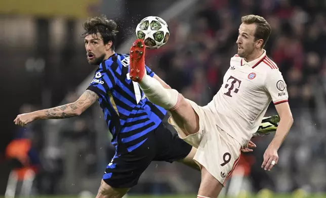 Munich's Harry Kane, right, and Inter's Francesco Acerbi fight for the ball during the Champions League quarterfinals first leg soccer match between FC Bayern Munich and Inter Milan, at the Allianz Arena in Munich, Germany, Tuesday, April 8, 2025. (Sven Hoppe/dpa via AP)