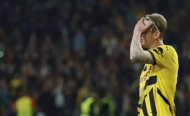 Dortmund's Julian Brandt reacts at the end of the Champions League quarterfinals first leg soccer match between Barcelona and Borussia Dortmund, at the Lluis Companys Olympic stadium in Barcelona, Spain, Wednesday, April 9, 2025. (AP Photo/Joan Monfort)