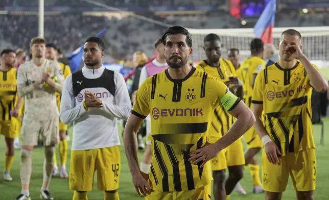 Dortmund's Emre Can, center, and his teammates react at the end of the Champions League quarterfinal first leg soccer match between Barcelona and Borussia Dortmund, at the Lluis Companys Olympic stadium in Barcelona, Spain, Wednesday, April 9, 2025. (AP Photo/Emilio Morenatti)