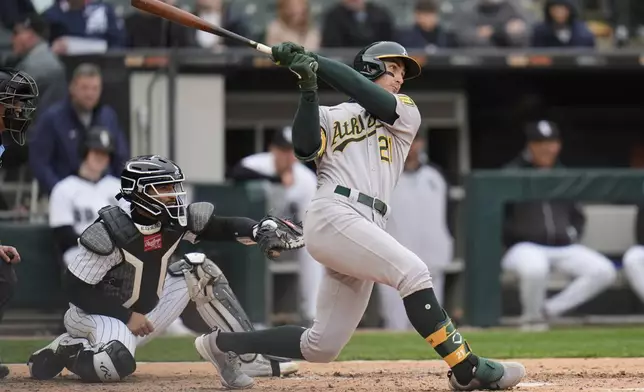 Athletics' Tyler Soderstrom, right, hits a home run during the seventh inning of a baseball game against the Chicago White Sox, Thursday, April 17, 2025, in Chicago. (AP Photo/Erin Hooley)