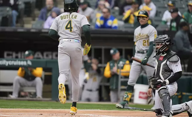 Athletics' Lawrence Butler (4) scores on a double from Jacob Wilson during the first inning of a baseball game against the Chicago White Sox, Thursday, April 17, 2025, in Chicago. (AP Photo/Erin Hooley)