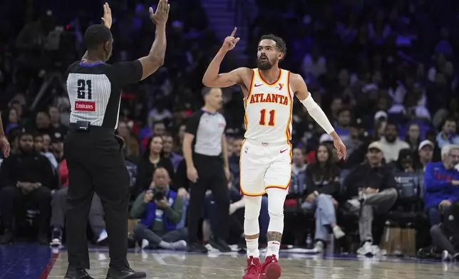 Atlanta Hawks' Trae Young reacts during the second half of an NBA basketball game against the Philadelphia 76ers, Friday, April 11, 2025, in Philadelphia. (AP Photo/Matt Rourke)