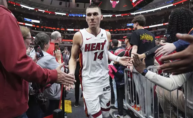 Miami Heat guard Tyler Herro celebrates with fans after the Heat defeated the Chicago Bulls in an NBA play-in tournament basketball game in Chicago, Wednesday, April 16, 2025. (AP Photo/Nam Y. Huh)
