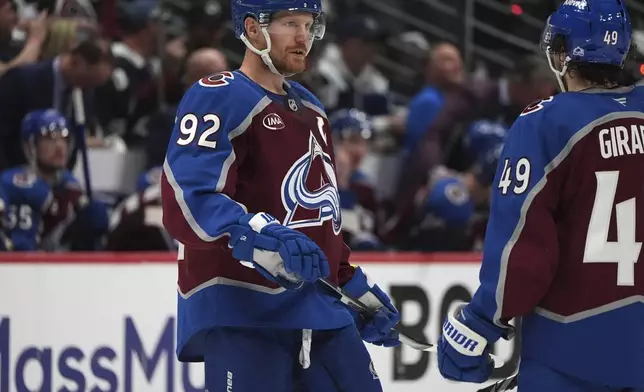 Colorado Avalanche left wing Gabriel Landeskog, left, confers with defenseman Samuel Girard in the second period of Game 4 of an NHL hockey first-round playoff series against the Dallas Stars Saturday, April 26, 2025, in Denver. (AP Photo/David Zalubowski)