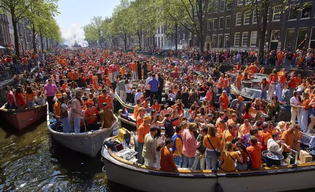 Herengrscht canal was jam-packed with boats as people celebrated King's Day in Amsterdam, Netherlands, Saturday, April 26, 2025. (AP Photo/Peter Dejong)