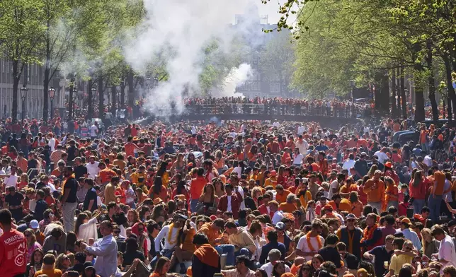 Herengracht canal was jam-packed with boats as people celebrated King's Day in Amsterdam, Netherlands, Saturday, April 26, 2025. (AP Photo/Peter Dejong)